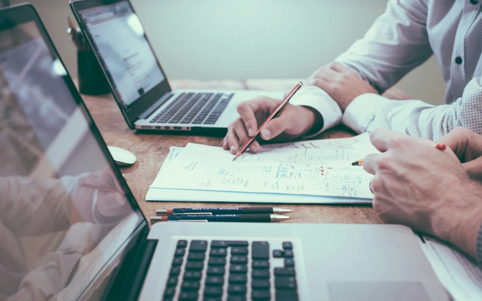 Planning notes and document checklist on a desk.
